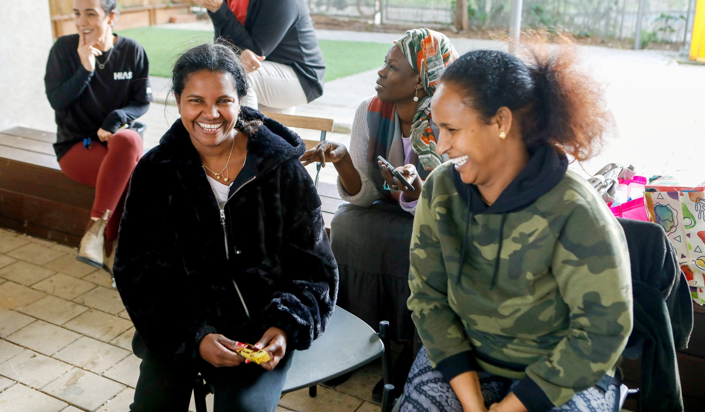 Yordanos (L) and Tagasti (R), two African asylum-seekers who live with their children in Israel, attend a food and other supplies distribution held by HIAS in Tel-Aviv on February, 14, 2024. (AG for HIAS)