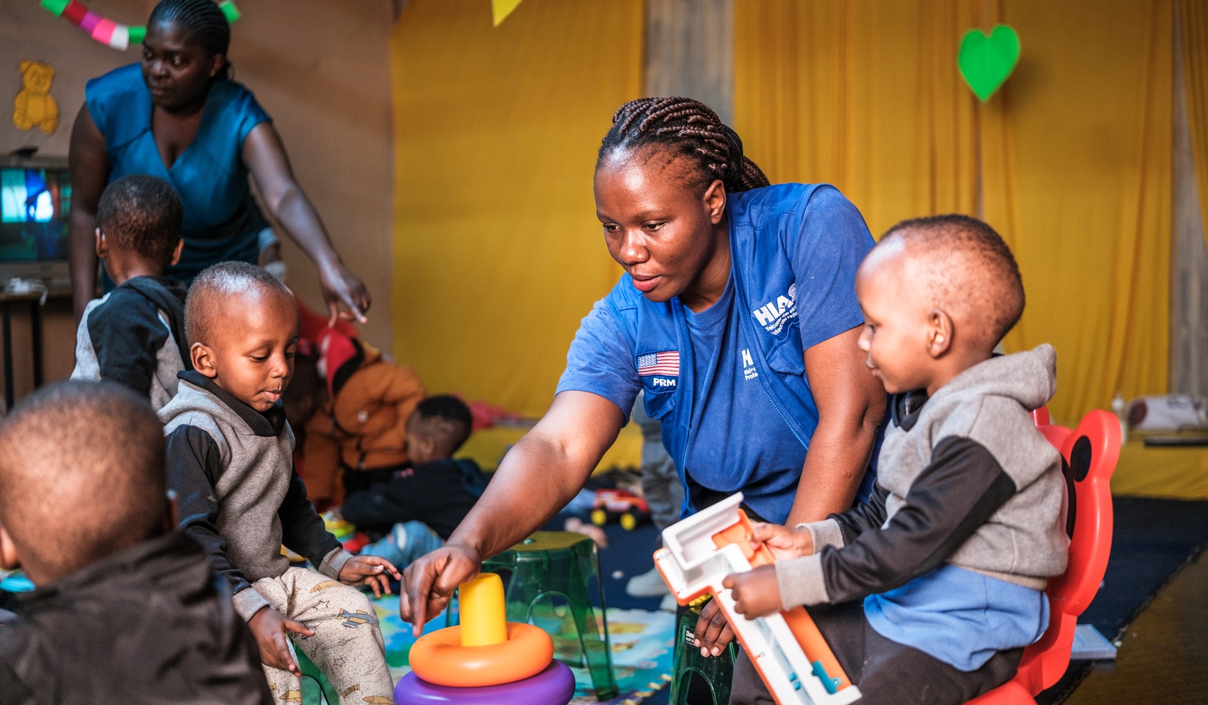 Gloria, a HIAS Kenya Child Protection Associate, interacts with refugee children in Nairobi in June 2026 (Brian Otieno for HIAS).